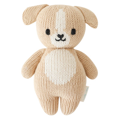Knitted dog toy with a white belly on a white background