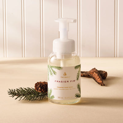 Frasier Fir foaming hand wash bottle with natural elements on a beige surface