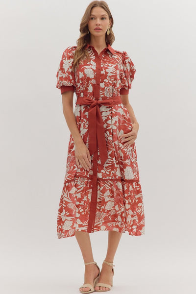 Woman wearing a red floral dress on a white background